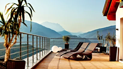 Balkon mit Liegestühlen und Bergblick an einem sonnigen Tag